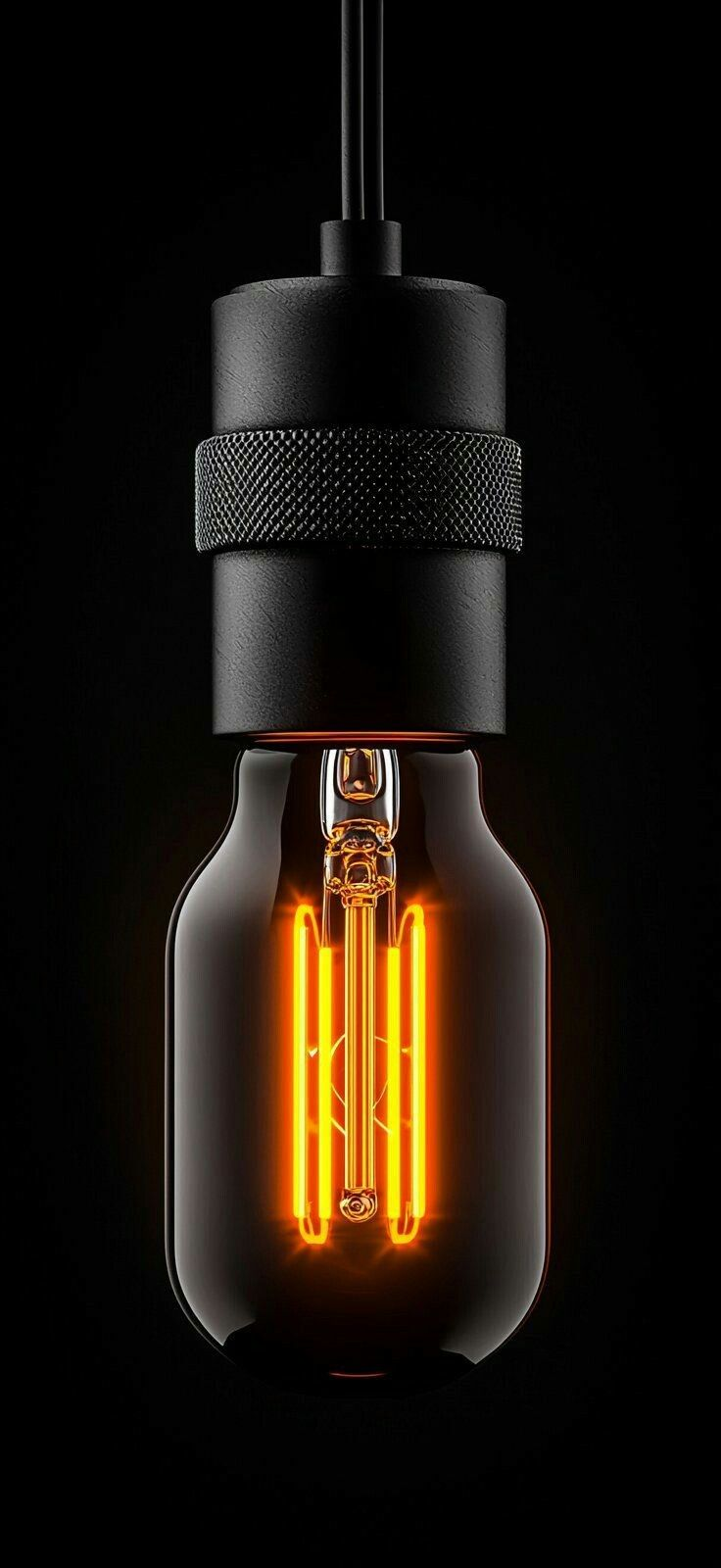 Pendant light bulb with glowing orange neon filament on a black background